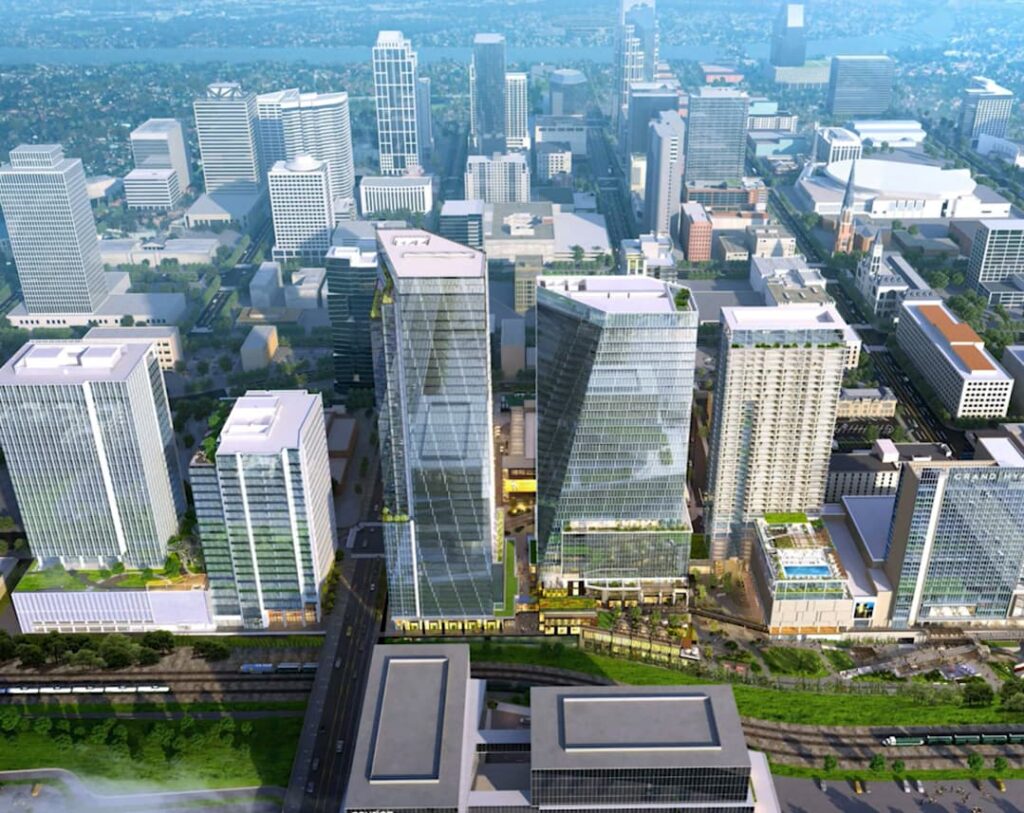 A conceptual rendering of a green, futuristic urban development with multiple skyscrapers