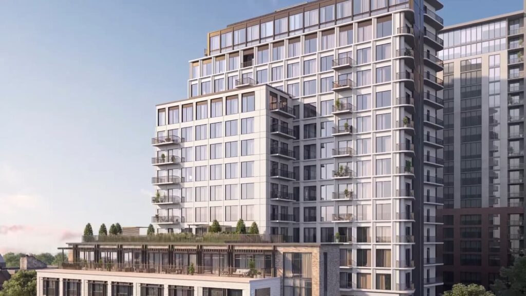 Modern multi-story building with large balconies and a rooftop garden